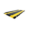 Justrite QuickBerm 14' x 54' x 4" Drive-Through Washdown Spill Containment Berm, 1800 Gallon, Low-Profile for Vehicle & Equipment Cleaning, black and yellow spill containment berm with durable material for vehicle washdown area.