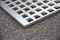 Grating is removable for easy clean-up and maintenance.