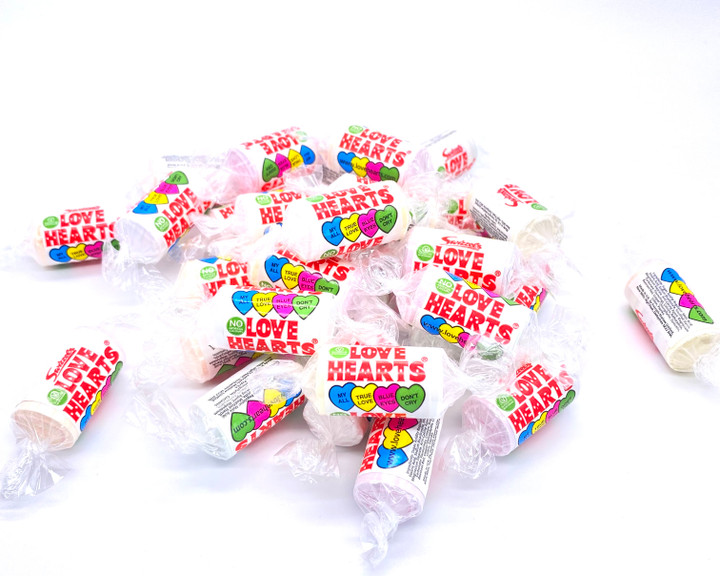 Swizzels Love Heart Mini Rolls - A teeny weeny packet filled with delicious tangy love hearts, and a cheeky message! A top 10 best seller, perfect for party bags, wedding favours and valentine's gifting. Retro classic.