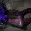 Gorgeous masquerade mask with purple glitter, purple feathers and netting.