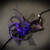 Masquerade mask with purple feathers and purple flowers.