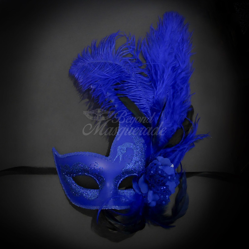 Royal blue feather masquerade mask complimented with a roman greek god masquerade mask. The men's masquerade mask is in silver and blue.