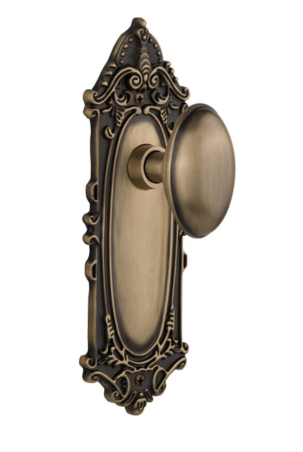 Nostalgic 704010: Victorian Backplate w/Homestead Knob Passage Door Set - Antique Brass