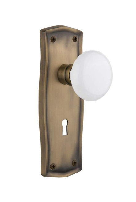 Nostalgic 704527: Prairie Backplate w/White Porcelain Knob Passage Door Set - Antique Brass