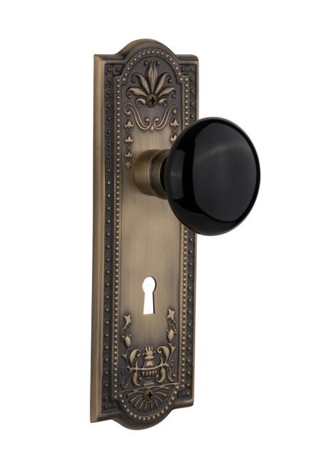 Nostalgic 710164: Meadows Backplate w/Black Porcelain Knob Single Dummy Door Set - Antique Brass