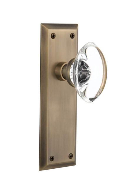 Nostalgic 711437: New York Backplate w/Oval Clear Glass Crystal Knob Single Dummy Door Set - Antique Brass