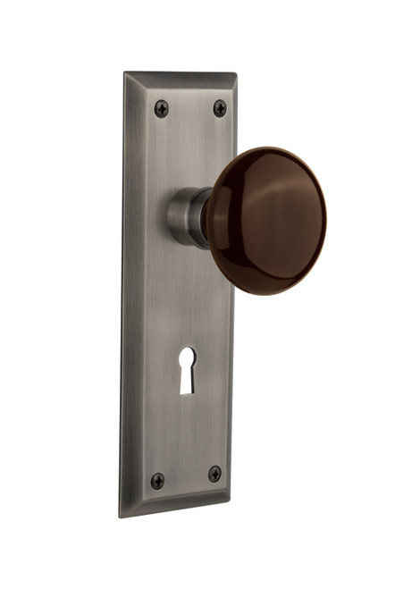 Nostalgic 710804: New York Backplate w/Brown Porcelain Knob Privacy Door Set - Antique Pewter