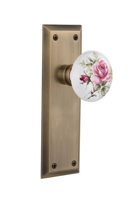Nostalgic 711189: New York Backplate w/White Rose Porcelain Knob Privacy Door Set - Antique Brass