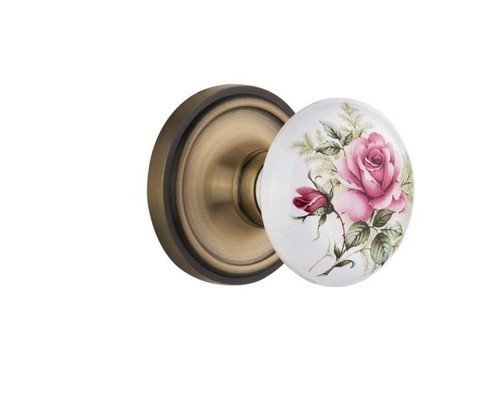 Nostalgic 710880: Classic Rosette w/White Rose Porcelain Knob Passage Door Set - Antique Brass