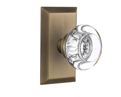 Nostalgic 713352: Studio Backplate w/Round Clear Glass Crystal Knob Privacy Door Set - Antique Brass