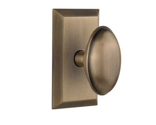 Nostalgic 713318: Studio Backplate w/Homestead Knob Privacy Door Set - Antique Brass
