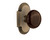 Nostalgic 712882: Cottage Backplate w/Brown Porcelain Knob Passage Door Set - Antique Brass