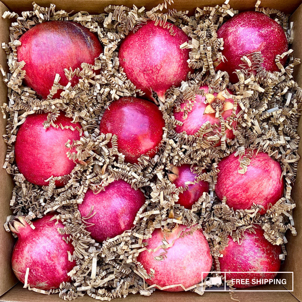A box overflowing with fresh, organic pomegranates!