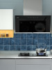 Marine blue peel and stick composite tiles installed behind a cooker demonstrating heat and humidity resistance