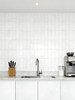 Ghost White peel and stick tiles installed on modern kitchen splashback with sink