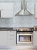 Silver Concrete peel and stick tiles used as kitchen splashback behind cooker