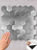 Easy-to-install stainless steel look hexagon tiles with a grout-free peel and stick adhesive backing.