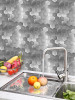Modern kitchen backsplash featuring brushed silver metal hexagon tiles that match stainless steel appliances.