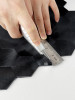 Demonstration of cutting a rigid 4mm matte black metal hexagon tile with a utility knife and metal ruler for a custom fit.
