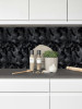 Contemporary kitchen interior with matte black hexagon composite wall tiles used for a sophisticated industrial look.