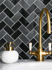 Modern kitchen backsplash featuring Onyx Black Herringbone composite peel and stick tiles.