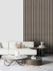 A modern living room wall covered in Layed Washed Walnut peel and stick slat panels.