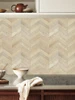 Easy DIY installation of Sonoma Oak wood chevron tiles on a clean interior wall surface.