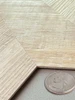 Close-up view of the realistic wood grain and texture on Sonoma Oak chevron composite wall tiles.