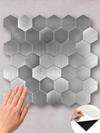 Easy-to-install stainless steel look hexagon tiles with a grout-free peel and stick adhesive backing.