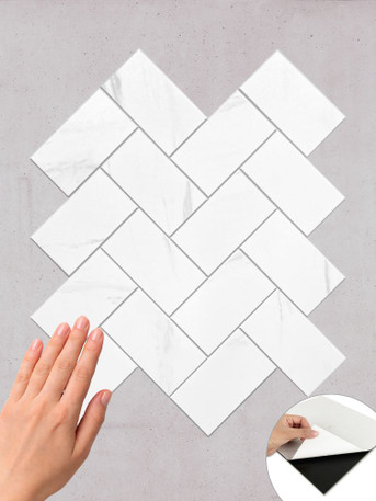 Layed CWHT01 Carrara White Herringbone peel and stick composite wall tile sheet.