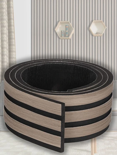 Flexible self-adhesive wood slatted wall panel rolled up, showcasing the realistic wood grain and black EVA foam backing.