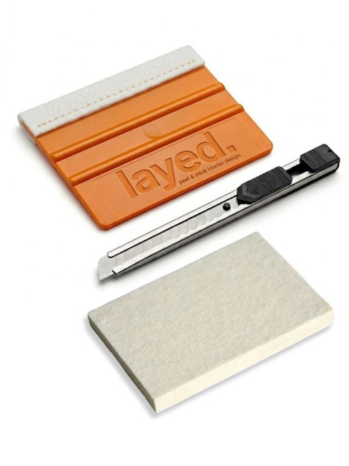 Essential tools for interior wrapping inclding a felt edge squeegee, wool block and a 9mm retractable knife. 