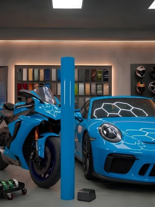 Sports car and motorcycle wrapped in Super Gloss Miami Blue vinyl wrap SG-MB18 beside standing roll