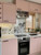 A funky kitchen finished in Pink Fabric Vinyl Wrap PF310, showcasing its soft pastel color and realistic woven textile texture.