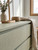 A close-up view of modern, handle-less dresser drawers wrapped in Smokey Sage Green Fabric Vinyl Wrap SSGF988, highlighting the film's soft, fabric-like finish and calming green tone.