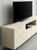 A bright flat-panel tv media unit wrapped in Ivory Stucco Plaster Vinyl Wrap ISP14.