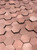 Detailed angled view showing the 3D interlocking texture and brushed metallic finish of the copper hexagon wall tiles.