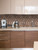 Kitchen counter with an espresso machine and stand mixer set against a warm 3D copper cube peel and stick tile backsplash.
