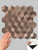Hand touching the textured surface of a Layed 3D copper tile sheet, with an inset showing the easy peel-and-stick adhesive backing.