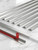 10-pack set of silver self-adhesive real aluminum tile edge trims showing peel-off red adhesive tape layer.