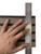 Stainless steel ruler placed vertically over a wood slat wall panel to measure and mark for precise cutting.