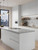 A budget-friendly DIY kitchen makeover featuring cabinets wrapped in a smooth eco matte white vinyl kit.