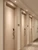 A brightly lit commercial hotel hallway showcasing multiple flush doors beautifully wrapped and modernized using Layed Pickled Oak Wood Vinyl Wrap.