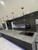 Another view of a contemporary kitchen showcasing a sleek black sink set into a striking kitchen island wrapped in Layed Orobico Grey Marble Vinyl Wrap.