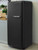 Retro-style kitchen refrigerator wrapped in Brushed Metal Black Vinyl BMB32 for a modern matte-metallic finish
