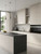 Modern kitchen doors wrapped in Layed Interior Film's Matte Textured Stone MTSG12, providing a clean, modern aesthetic without the need for paint.