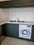 Kitchen base cabinets flawlessly upgraded with Layed Matte Silk Dark Olive Green Vinyl Wrap, positioned next to a washing machine under a marble-effect counter.