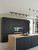 Close-up of modern kitchen cabinets wrapped in Layed Matte Silk Black Charcoal vinyl, contrasting beautifully with a light wood countertop.