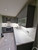 A contemporary kitchen featuring countertops and a backsplash flawlessly upgraded using Layed Calacatta White Marble Vinyl Wrap, paired with grey cabinetry.
