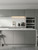 A modern kitchen transformation featuring cabinets newly finished in Layed premium interior matte vinyl wrap in charcoal grey.